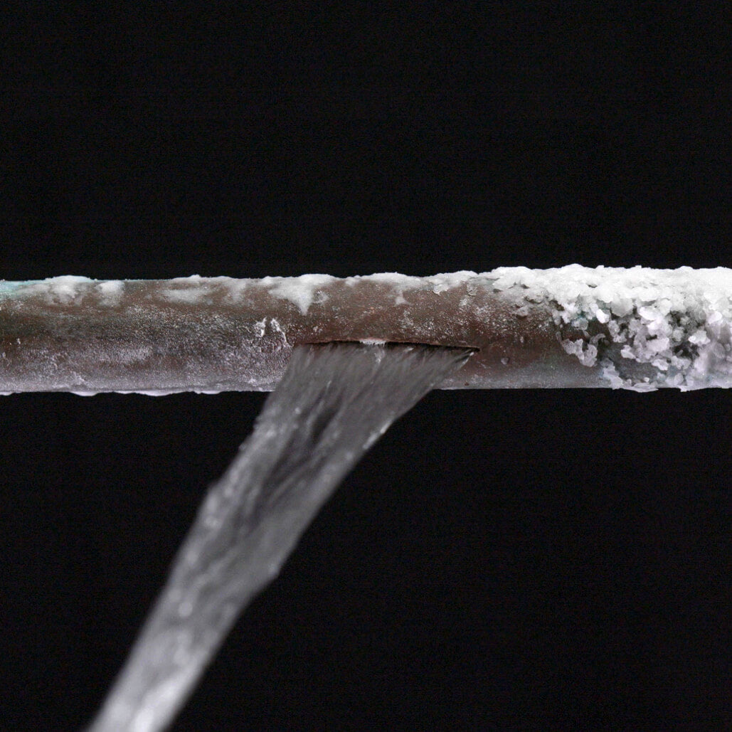 A cracked pipe leaking water