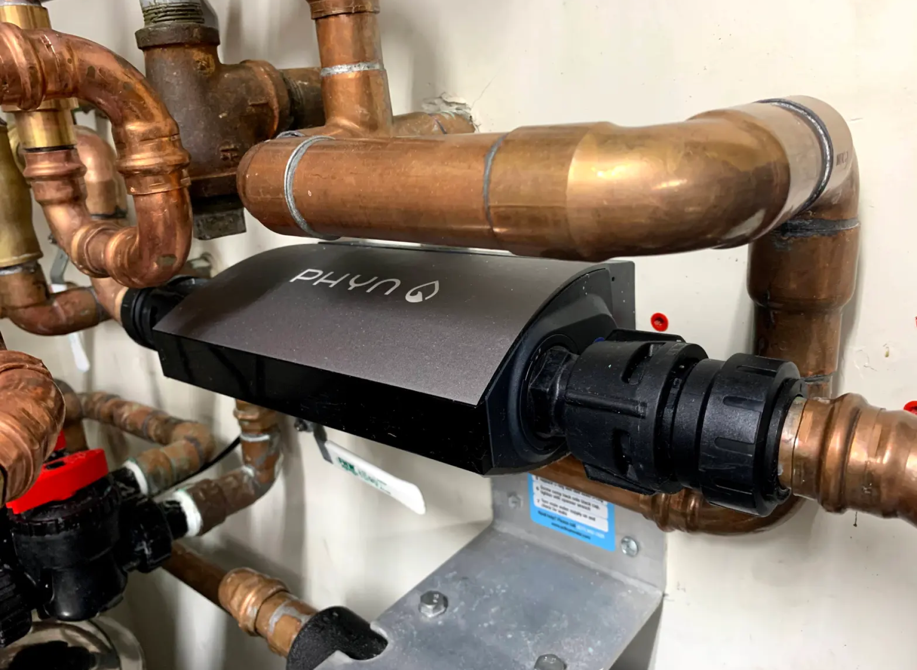 The Phyn Smart Sensor installed with pipes