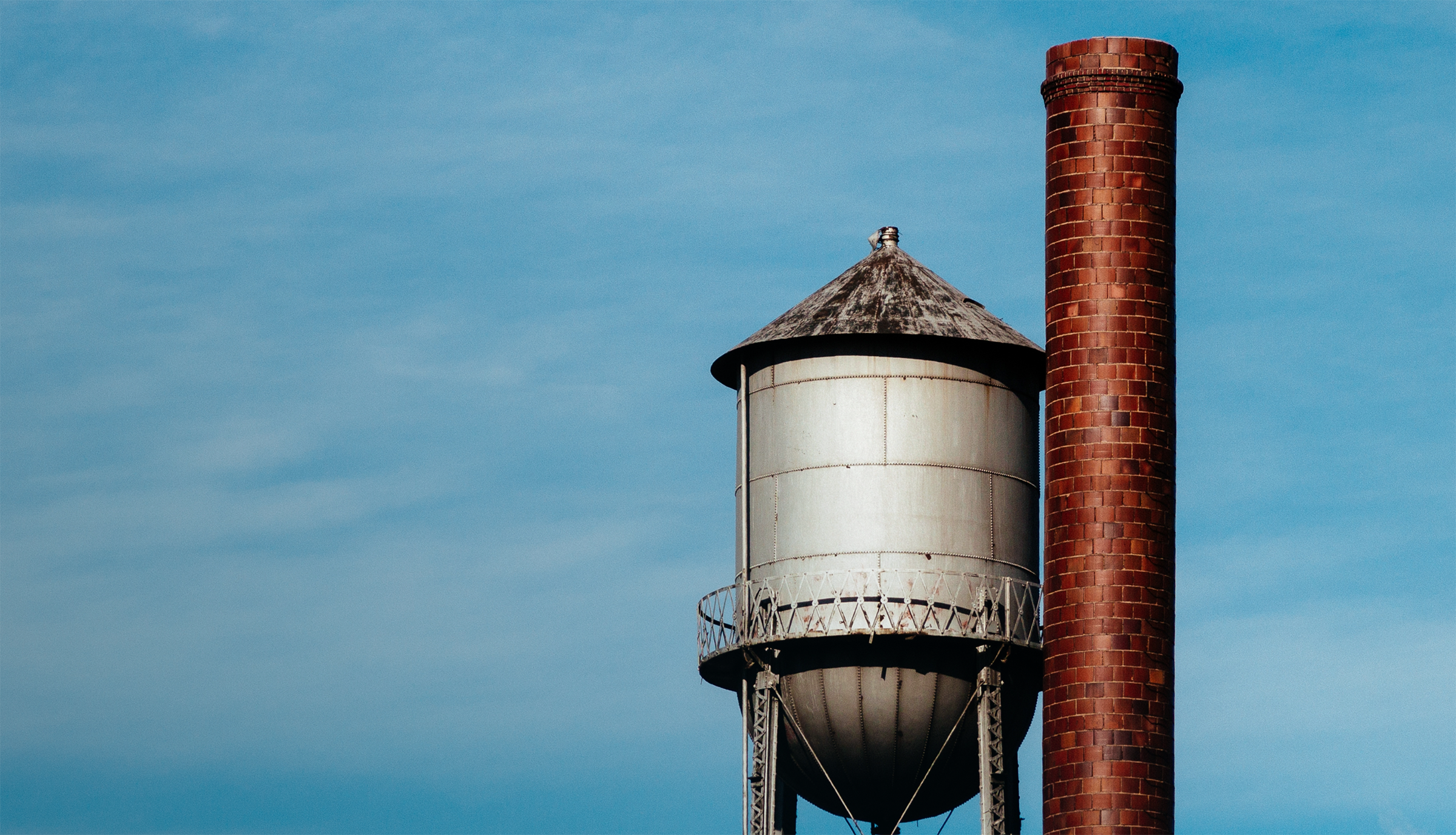A water tower and a smokestack