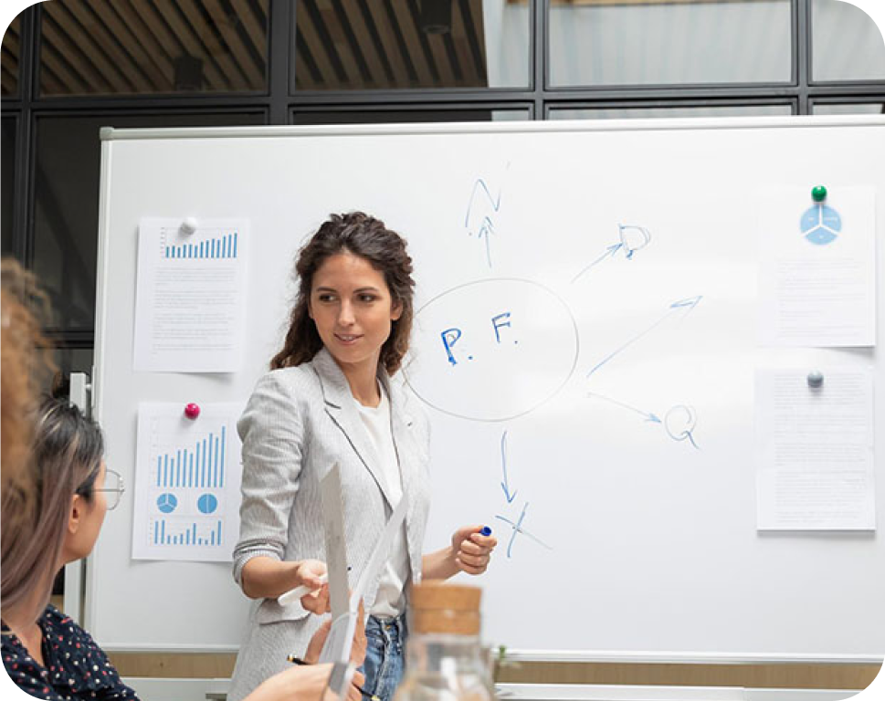 A woman writing on a blackboard.